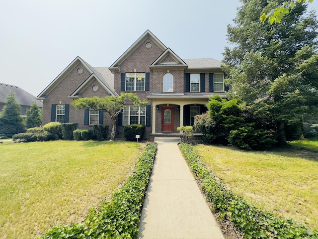 3217 Malone Dr, Lexington, KY 40513 - view of front of home with brick siding, a front lawn, and covered porch