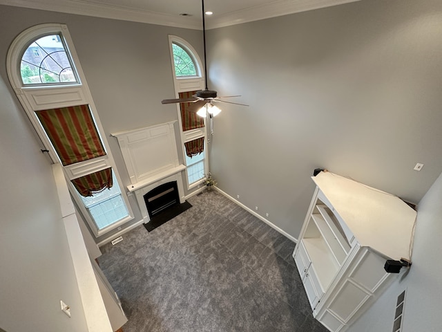 3217 Malone Dr, Lexington, KY 40513 - unfurnished living room featuring dark colored carpet, plenty of natural light, a fireplace with flush hearth, baseboards, and ornamental molding