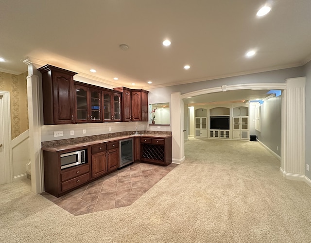 3217 Malone Dr, Lexington, KY 40513 - indoor bar with ornamental molding, light colored carpet, stainless steel microwave, arched walkways, and beverage cooler