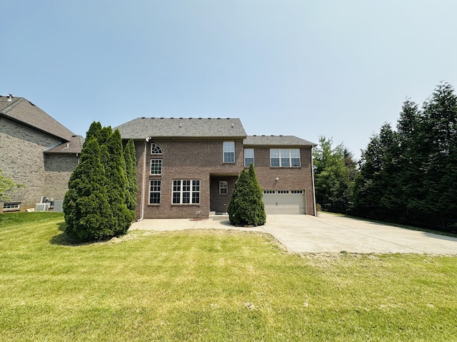 3217 Malone Dr, Lexington, KY 40513 - back of property featuring concrete driveway, an attached garage, a yard, and brick siding