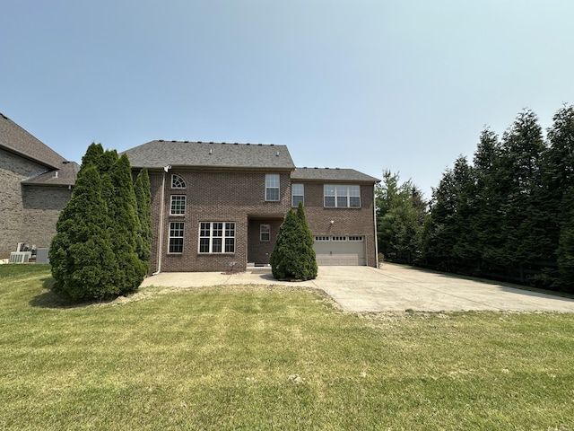 3217 Malone Dr, Lexington, KY 40513 - view of front of home featuring driveway, an attached garage, a front lawn, and brick siding