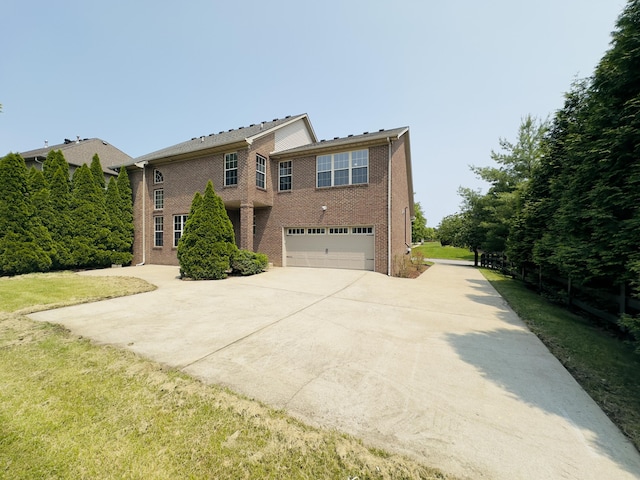 3217 Malone Dr, Lexington, KY 40513 - view of front of property with driveway, an attached garage, brick siding, and a front yard