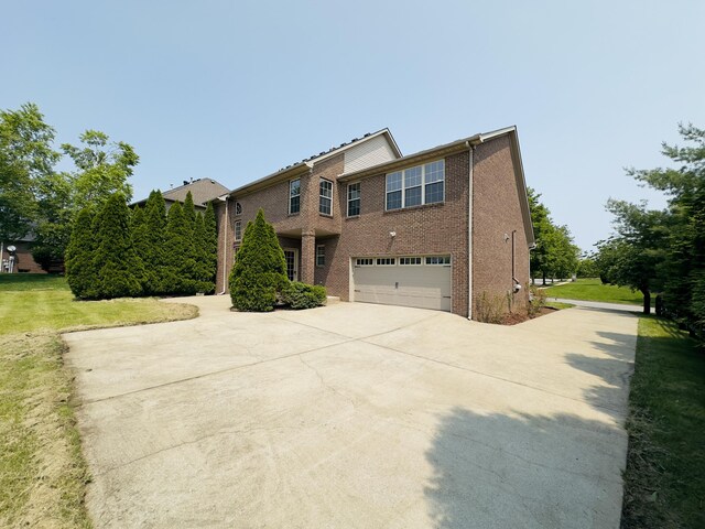 3217 Malone Dr, Lexington, KY 40513 - view of side of home featuring concrete driveway, a garage, and brick siding