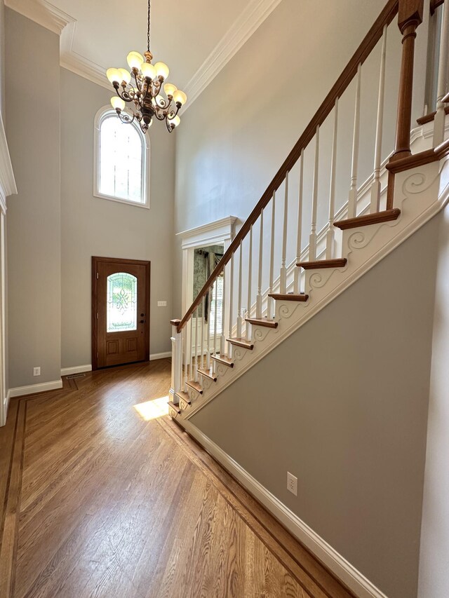 3217 Malone Dr, Lexington, KY 40513 - foyer with a chandelier, stairs, a towering ceiling, baseboards, and crown molding