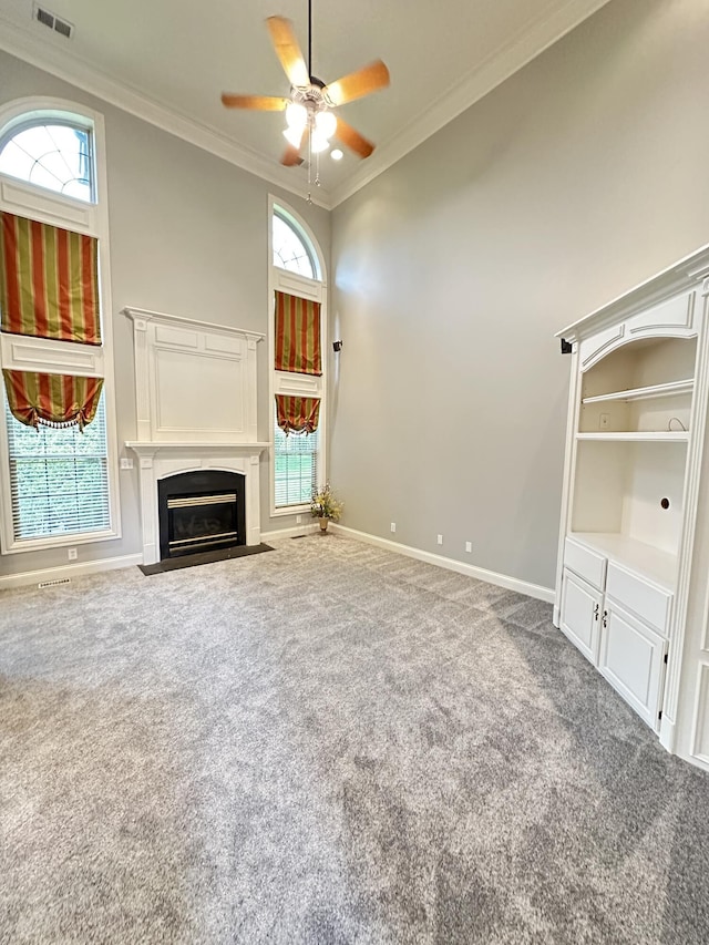 3217 Malone Dr, Lexington, KY 40513 - unfurnished living room with ornamental molding, carpet, baseboards, a ceiling fan, and a fireplace with flush hearth
