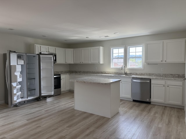 277 Broadway St A-B, Unit A-B Irvine, KY 40336 - kitchen with stainless steel appliances, light wood-style flooring, and white cabinets