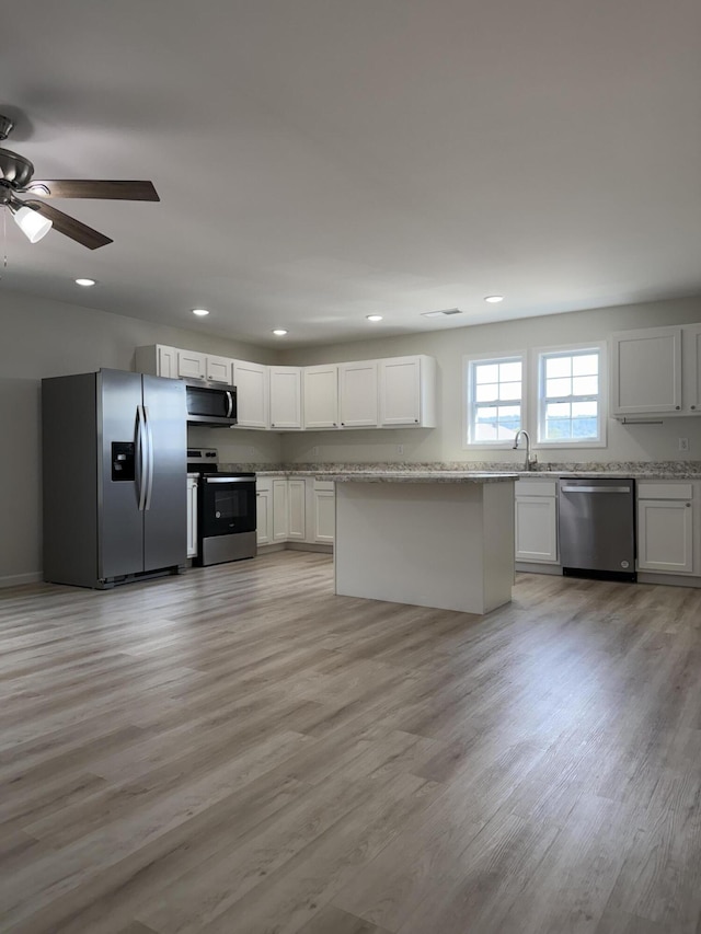 277 Broadway St A-B, Unit A-B Irvine, KY 40336 - kitchen featuring stainless steel appliances, ceiling fan, light wood-style flooring, recessed lighting, and light stone counters
