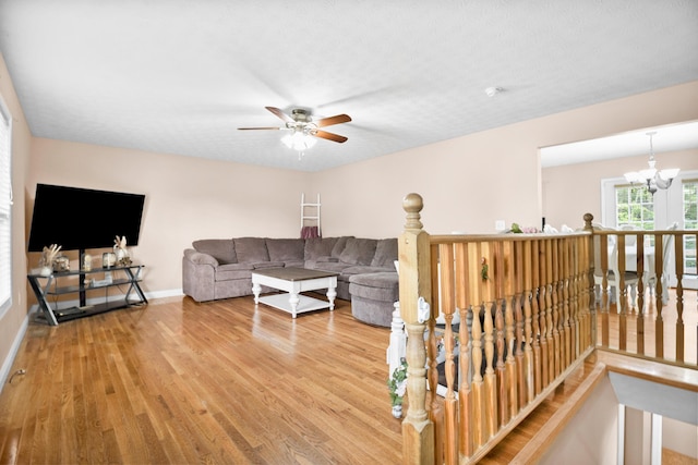 15 April Ln, Corbin, KY 40701 - living room with wood finished floors, a ceiling fan, a chandelier, and baseboards