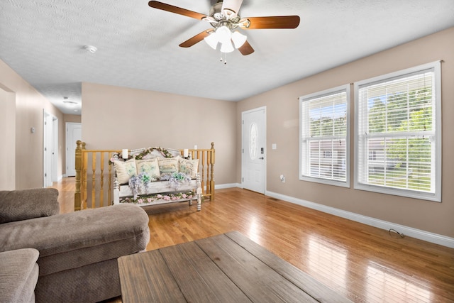 15 April Ln, Corbin, KY 40701 - living area with light wood-type flooring, baseboards, ceiling fan, and a textured ceiling