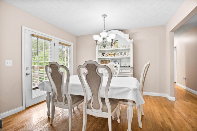 15 April Ln, Corbin, KY 40701 - dining space featuring a chandelier, light wood-style floors, and baseboards