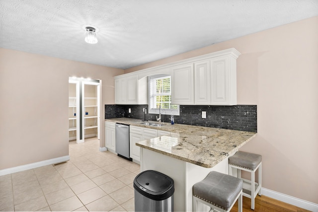 15 April Ln, Corbin, KY 40701 - kitchen with a sink, dishwasher, backsplash, baseboards, and a textured ceiling