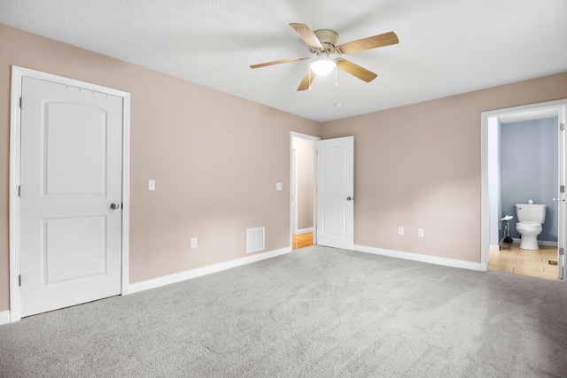 15 April Ln, Corbin, KY 40701 - unfurnished bedroom with carpet floors, baseboards, ensuite bath, and a ceiling fan