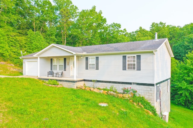 15 April Ln, Corbin, KY 40701 - view of front of property featuring covered porch, a front yard, and a garage