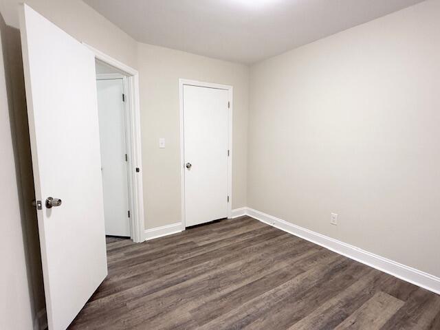 3501 Marsanne Ct, Lexington, KY 40515 - unfurnished bedroom with dark wood-type flooring and baseboards