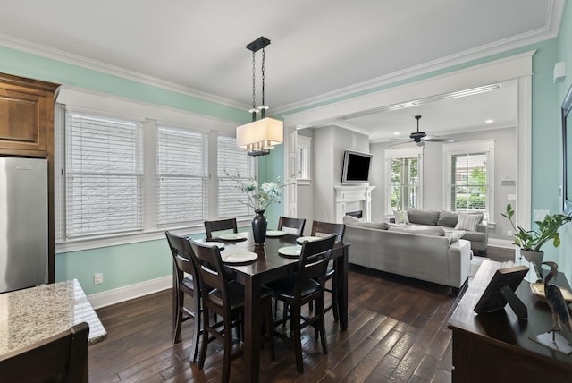 10910 Kings Crown Dr, Prospect, KY 40059 - dining area featuring baseboards, dark wood-type flooring, ceiling fan, a fireplace, and ornamental molding