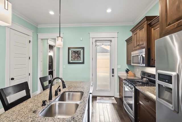 10910 Kings Crown Dr, Prospect, KY 40059 - kitchen with appliances with stainless steel finishes, a sink, dark wood-style flooring, light stone countertops, and crown molding