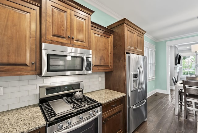 10910 Kings Crown Dr, Prospect, KY 40059 - kitchen with appliances with stainless steel finishes, baseboards, crown molding, dark wood finished floors, and light stone countertops