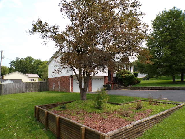 706 Allf Ln, London, KY 40741 - view of yard featuring asphalt driveway and a garage