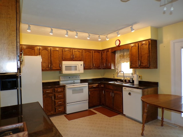 706 Allf Ln, London, KY 40741 - kitchen with white appliances, a sink, dark countertops, light flooring, and rail lighting