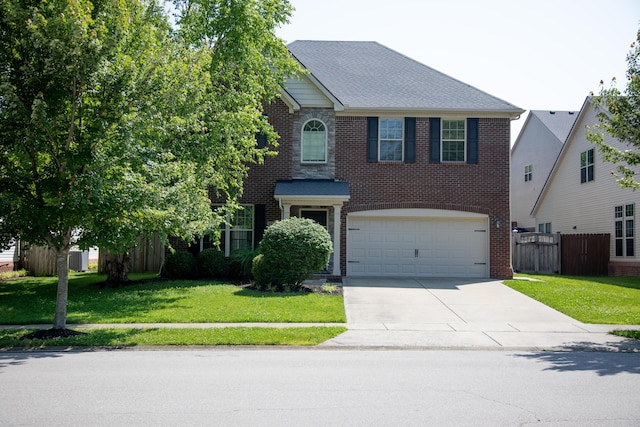 4745 Willman Way, Lexington, KY 40509 - traditional-style house featuring driveway, a garage, and brick siding