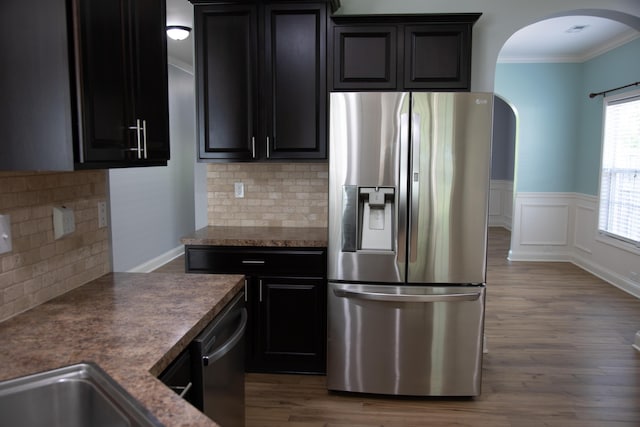 4745 Willman Way, Lexington, KY 40509 - kitchen featuring stainless steel appliances, arched walkways, ornamental molding, decorative backsplash, and wood finished floors