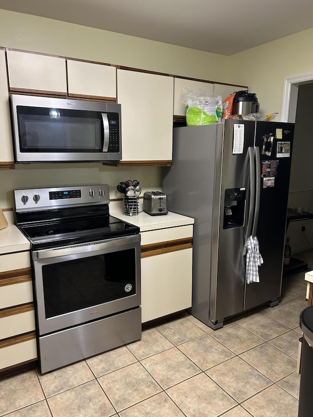 1125 Turkey Foot Rd Unit 3, Lexington, KY 40502 - kitchen with appliances with stainless steel finishes, light countertops, white cabinets, and light tile patterned flooring