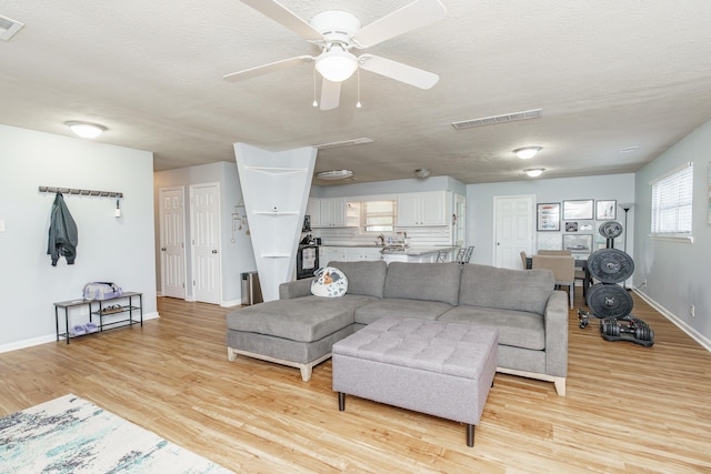 2812 Winter Park Dr, Lexington, KY 40517 - living area featuring baseboards, light wood finished floors, a textured ceiling, and ceiling fan