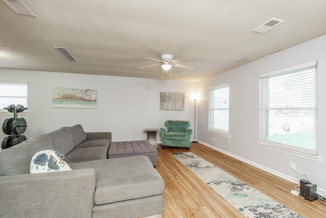 2812 Winter Park Dr, Lexington, KY 40517 - living room with a ceiling fan, wood finished floors, baseboards, and a textured ceiling