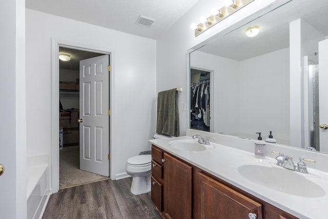 753 Woodhaven Pl, Lexington, KY 40514 - full bath with wood finished floors, double vanity, a walk in closet, and toilet
