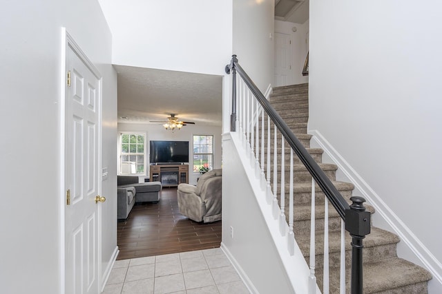 753 Woodhaven Pl, Lexington, KY 40514 - stairway featuring ceiling fan, tile patterned flooring, a textured ceiling, and baseboards