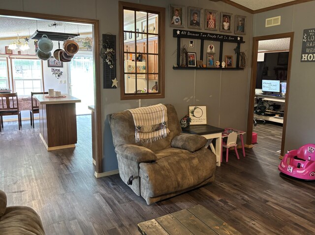 27 Dishman Ln, Monticello, KY 42633 - living room featuring a chandelier, wood finished floors, crown molding, and lofted ceiling