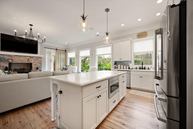 4291 Captains Ct, Lexington, KY 40513 - kitchen with appliances with stainless steel finishes, crown molding, light countertops, white cabinets, and pendant lighting