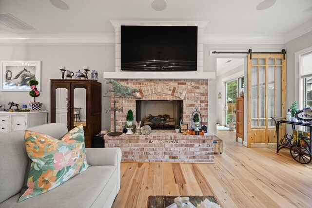 4291 Captains Ct, Lexington, KY 40513 - living area featuring ornamental molding, hardwood / wood-style floors, a barn door, and a fireplace