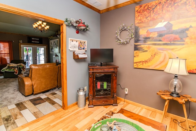 3900 Upper Sharpsburg, Carlisle, KY 40311 - living room featuring wood finished floors, french doors, a chandelier, crown molding, and baseboards