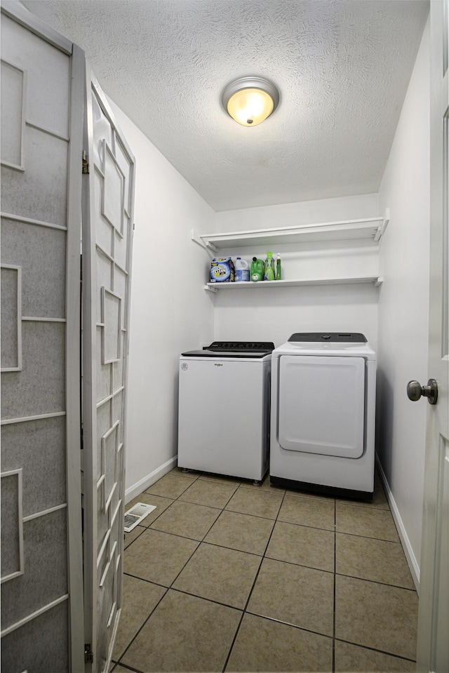 113 Bramble Ct, Nicholasville, KY 40356 - laundry area featuring separate washer and dryer, tile patterned floors, baseboards, and a textured ceiling
