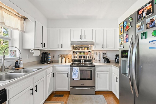 1008 Ramsey Branch Rd, Artemus, KY 40903 - kitchen featuring stainless steel appliances, a sink, extractor fan, light wood finished floors, and light countertops