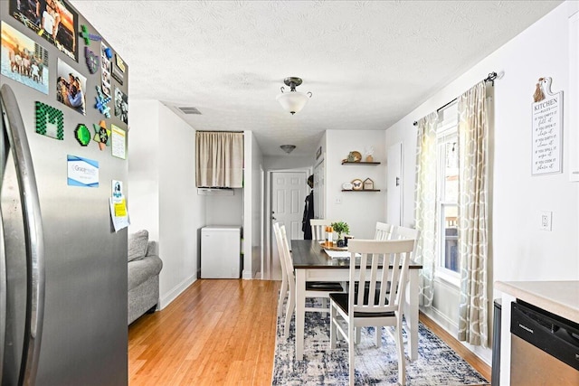 1008 Ramsey Branch Rd, Artemus, KY 40903 - dining space with light wood-style floors, baseboards, and a textured ceiling