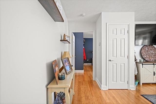 1008 Ramsey Branch Rd, Artemus, KY 40903 - hall featuring light wood finished floors, baseboards, and a textured ceiling