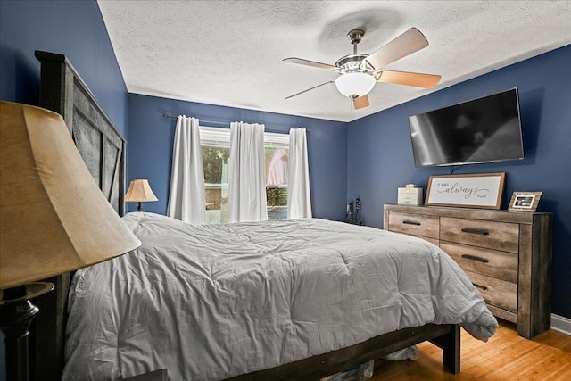 1008 Ramsey Branch Rd, Artemus, KY 40903 - bedroom featuring wood finished floors, ceiling fan, a textured ceiling, and baseboards