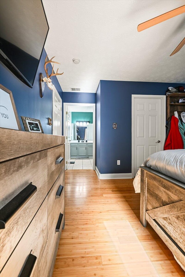 1008 Ramsey Branch Rd, Artemus, KY 40903 - bedroom with light wood-style floors, ensuite bath, baseboards, and ceiling fan