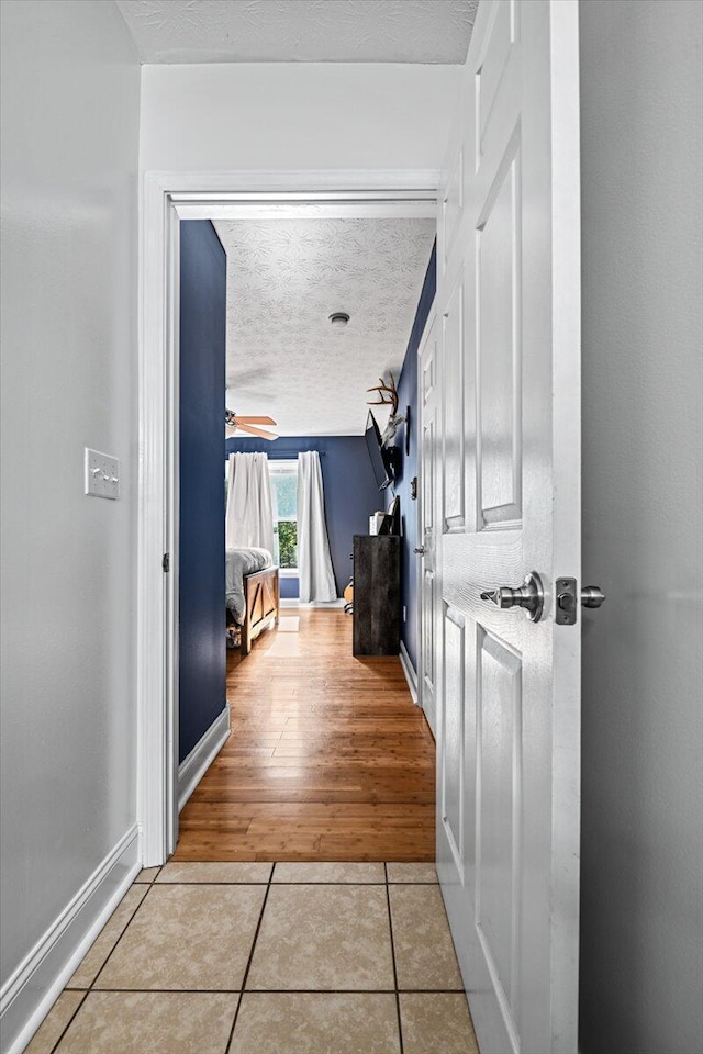 1008 Ramsey Branch Rd, Artemus, KY 40903 - corridor with tile patterned floors, a textured ceiling, and baseboards