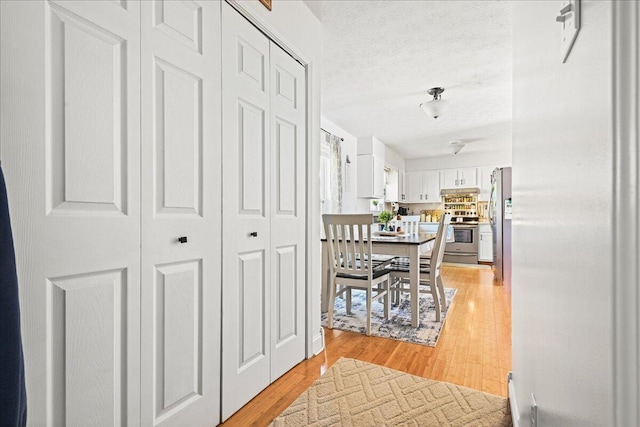1008 Ramsey Branch Rd, Artemus, KY 40903 - hallway with light wood-type flooring and a textured ceiling