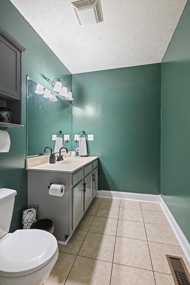1008 Ramsey Branch Rd, Artemus, KY 40903 - half bathroom with tile patterned flooring, toilet, vanity, a textured ceiling, and baseboards