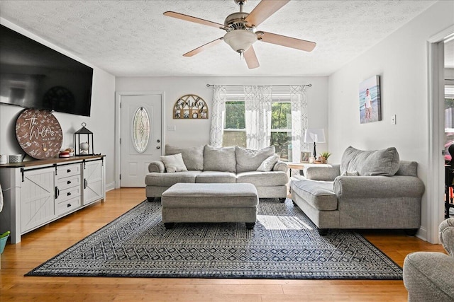 1008 Ramsey Branch Rd, Artemus, KY 40903 - living room with light wood finished floors, a textured ceiling, and ceiling fan