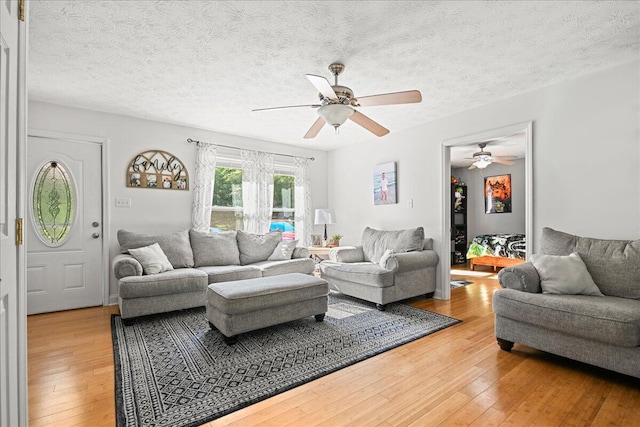 1008 Ramsey Branch Rd, Artemus, KY 40903 - living room featuring a ceiling fan, light wood-type flooring, and a textured ceiling