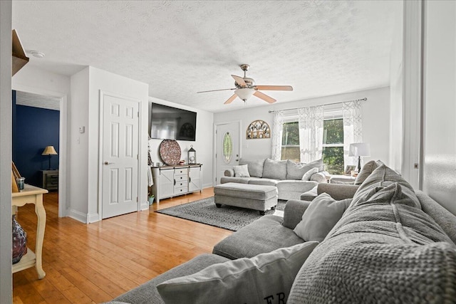 1008 Ramsey Branch Rd, Artemus, KY 40903 - living area with a ceiling fan, wood finished floors, a textured ceiling, and baseboards