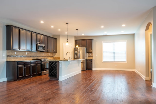 1805 Rachels Run, Lexington, KY 40509 - kitchen with stainless steel appliances, backsplash, dark brown cabinets, dark wood finished floors, and recessed lighting