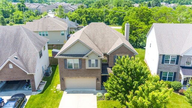 1805 Rachels Run, Lexington, KY 40509 - view of front of home featuring brick siding, concrete driveway, an attached garage, a chimney, and cooling unit