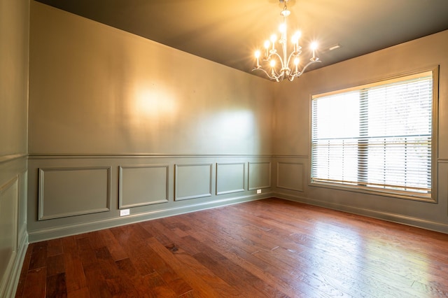 1805 Rachels Run, Lexington, KY 40509 - spare room featuring a decorative wall, a chandelier, dark wood-style floors, and wainscoting