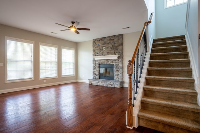 1805 Rachels Run, Lexington, KY 40509 - unfurnished living room featuring ceiling fan, dark wood-style floors, stairs, a fireplace, and healthy amount of natural light